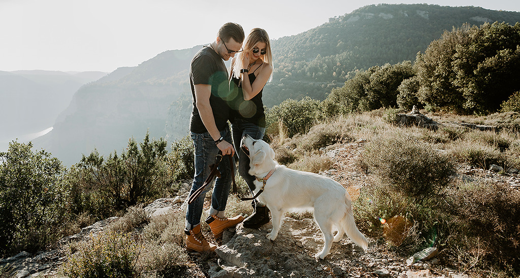 Vlad and Nastya with a dog standing on the top of rock