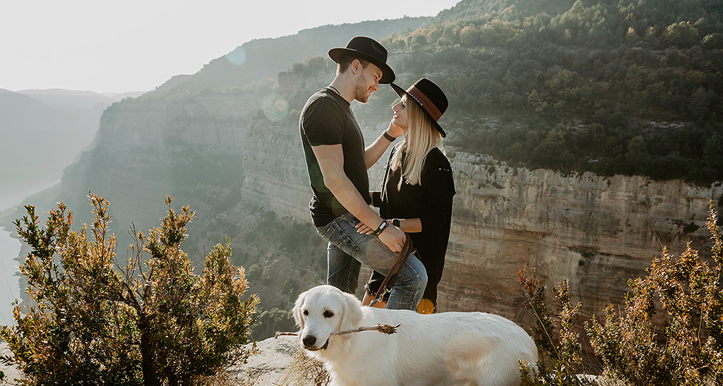 Vlad and Nastya with a dog standing on the top of rock