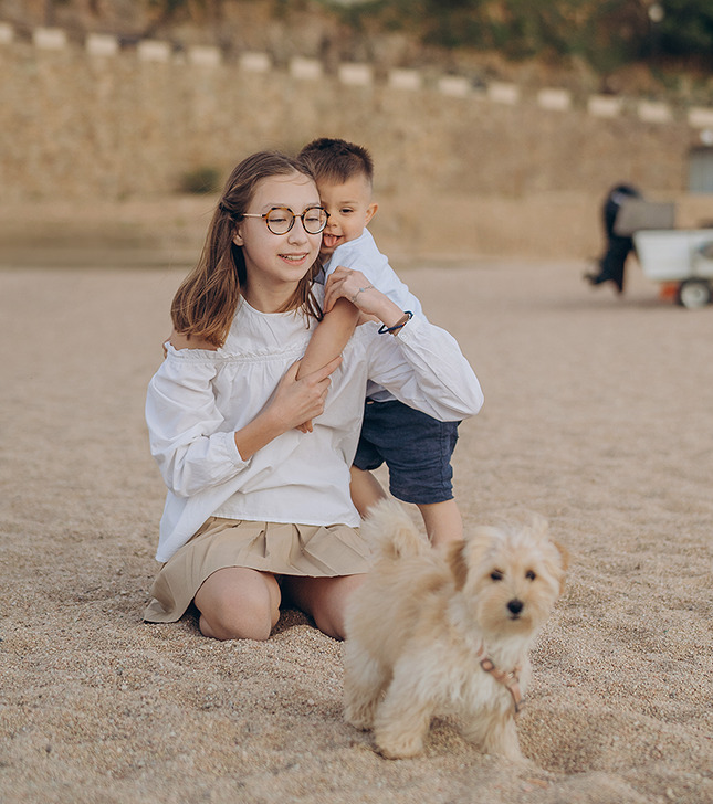 Kids with a dog on the beach
